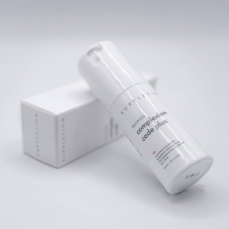 Skincare product with 'complexion code plus' text on a light gray background